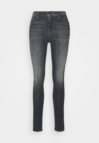 Jeans skinny neri in tessuto sbiadito con una finitura strappata. Caratterizzati da una vita media e cinque tasche. Chiusura frontale con bottone e zip.