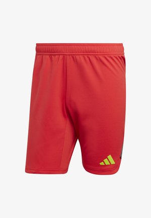 Shorts de sport rouges en tissu léger, avec une taille élastique, des panneaux latéraux et des accents verts près de l'ourlet.