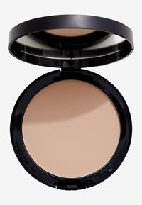 Kompakt puder med en slät, ljusbeige yta. Har ett glänsande svart runt etui med en klar spegel inuti.