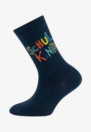 Chaussettes bleu marine en matériau côtelé, arborant le texte multicolore "SCHUL KIND" dans des polices de caractères variées et ludiques. Longueur standard jusqu'aux chevilles.