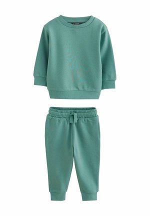 Grøn sweatshirt og matchende joggere lavet af blødt bomuldsstof. Sættet har en ribbet halsudskæring og manchetter samt en elastisk talje på bukserne.