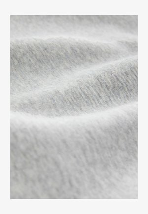 Heled hall kangas pehmea ja sileda tekstuuriga; sellel on õrnad variatsioonid varjundites, mis on iseloomulikud puuvilla või jersey materjalile.