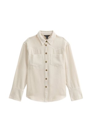 Camisa de pana beige de manga larga con botones en el frente, dos bolsillos en el pecho, cuello puntiagudo y puños anchos.