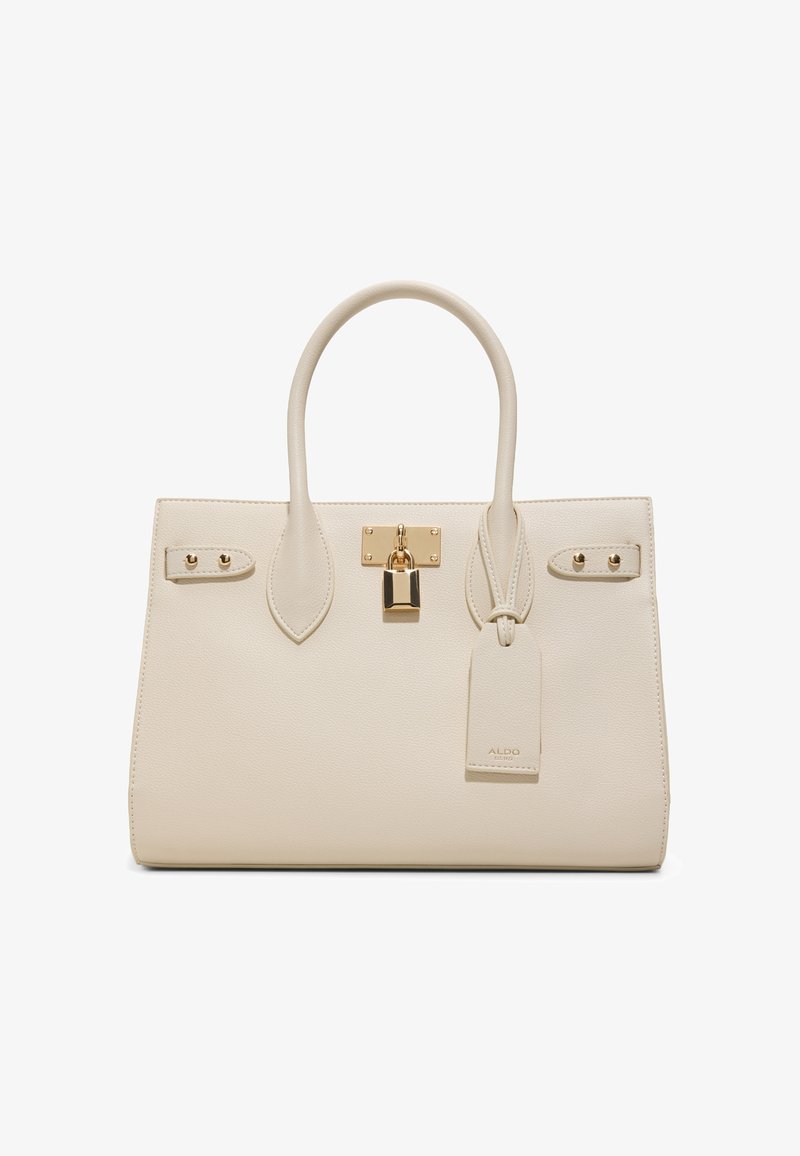 Kermanvärinen muotoiltu käsilaukku, jossa on kaksi kahvaa, kullanvärinen lukko ja edessä kiinnitetty merkintätunniste, jossa on hienovarainen bränditeksti.