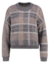 Lyhythihainen, lyhennetty neule harmaassa ja ruskeassa ruutukuviossa. Valmistettu pehmeästä, tekstuurillisesta kankaasta, jossa resorit hihansuissa ja kaula-aukossa.