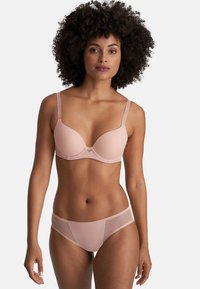 Light pink bra with smooth, padded cups and thin adjustable straps, paired with matching sheer panel brief. Simple, seamless design.