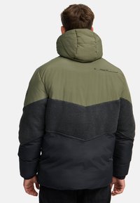 Puffer jacket featuring a green, gray, and black color block design, textured fabric, adjustable hood, and a logo detail on the back.