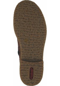 Suela de zapato de goma marrón con una superficie texturada. Presenta un logo visible y un patrón de piso distintivo. Diseño sólido y duradero.