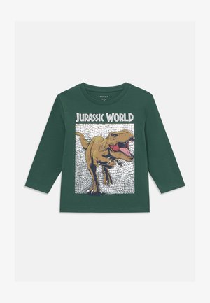 Green long-sleeve T-shirt featuring a graphic of a roaring dinosaur and the text “Jurassic World” on a textured print background.