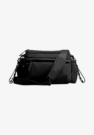 Black crossbody bag with multiple zippered compartments, nylon material, adjustable strap, and textured surface accents. Compact and functional design.