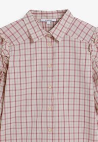 Camisa de botones a cuadros en beige claro con rejilla en rosa y blanco. Presenta volantes en los hombros y cuatro botones de color claro en el frente.