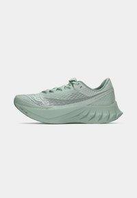Light green running shoe with mesh upper, textured accents, and curved outsole. Features reflective detailing and a cushioned, aerodynamic design.