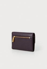 Dark purple textured leather wallet with a gold zipper and hardware. Compact rectangular shape with one exterior zip pocket.