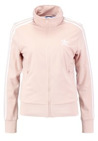 Ljusrosa zip-up träningsjacka i slätt material, med vita tre-randiga accenter på ärmarna och en broderad logotyp på bröstet.