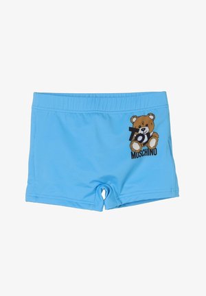 Costume da bagno per bambini azzurro chiaro con vita elastica, caratterizzato da una grafica di un orsacchiotto e dal testo "Toy Moschino" sul lato destro anteriore.