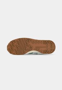 Black and white sneaker sole with a tan rubber outsole featuring a rugged tread pattern and "Converse" branding.