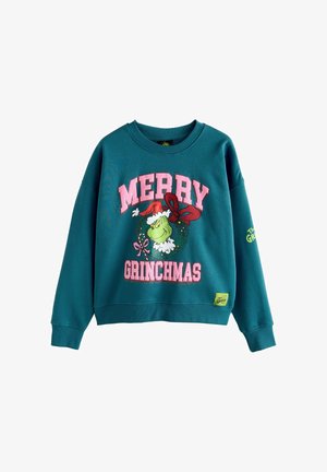 Teal sweatshirt met een bedrukt ontwerp van "MERRY GRINCHMAS" in het roze, een Grinch-graphic en een groene logo patch aan de onderrand.