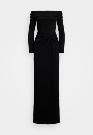 Vestido longo preto com decote ombro a ombro e mangas longas, apresentando um detalhe de nó torcido na cintura e uma silhueta de saia reta.