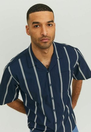 Navy short-sleeve shirt with white vertical stripes, button front, notch collar, and single chest pocket. Lightweight fabric texture.