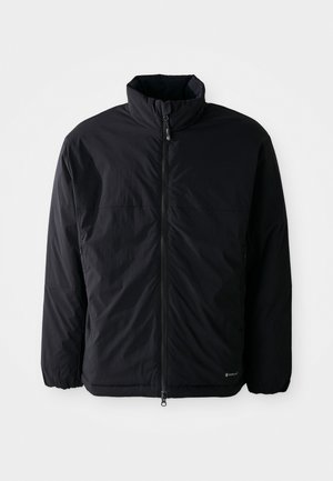 Black lightweight puffer jacket with high collar, front zipper closure, elastic cuffs, and small logo on lower right side.