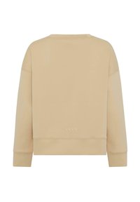 Beige cropped sweatshirt with long sleeves, round neckline, and ribbed cuffs. Subtle logo detail near the hem. Soft, smooth fabric texture.