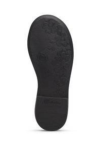 Suola di scarpa nera in gomma con motivi floreali in rilievo e scanalature per aderenza, con marchio nella zona del tallone.