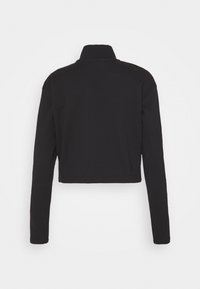 Giacca cropped nera con maniche lunghe e colletto alla coreana, realizzata in tessuto morbido. Presenta linee pulite e un design semplice senza decorazioni.