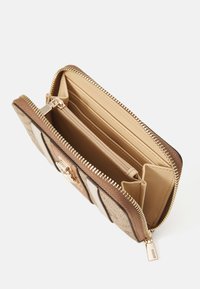 Zippered wallet in tan, featuring a mix of textured and smooth materials, multiple card slots, a central compartment, and gold-tone hardware.