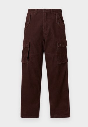 Brown corduroy cargo pants with wide legs, featuring large side pockets, vertical ribbing texture, and button closures.