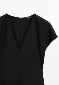 Abito nero con scollatura a V e maniche corte. Presenta una zip nascosta sul retro. Tessuto liscio, design minimalista.