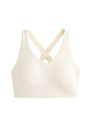 Sostenitore sportivo bianco con scollo a V, spalline incrociate e tessuto liscio e elasticizzato. Nessun hardware visibile o motivi.