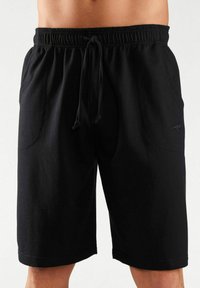 Black drawstring shorts made of soft fabric, featuring two side pockets and a subtle logo detail on the lower leg.