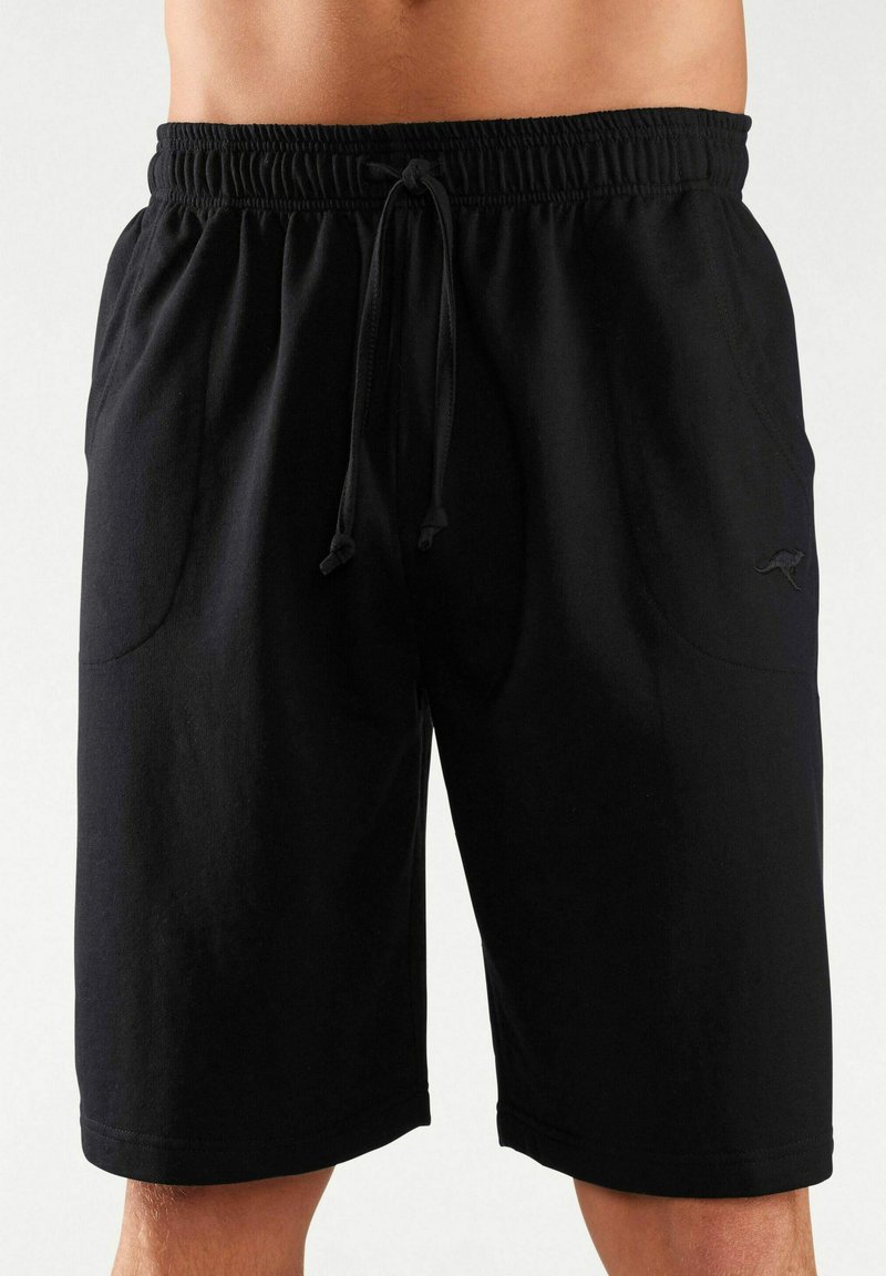 Black drawstring shorts made of soft fabric, featuring two side pockets and a subtle logo detail on the lower leg.