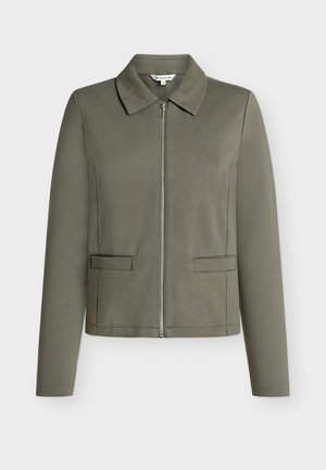 Olive green zip-up jacket with a pointed collar, long sleeves, and two front pockets. Made from textured fabric.