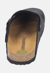 Black leather clog with cork footbed and textured sole. Interior features a smooth surface with the brand logo printed in green.