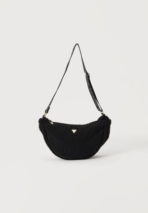 Sac d'épaule noir duveteux en forme de croissant avec une bandoulière réglable et un petit logo métallique triangulaire à l'avant.