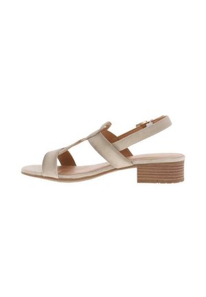 Sandale à talon compensé en cuir beige avec deux brides croisées, un petit talon en bois et une boucle réglable à la cheville. Texture lisse et design minimaliste.
