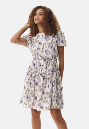 Floral knee-length dress with puff sleeves, purple and cream pattern, cinched waist with a belt, ruffled hem, lightweight fabric.