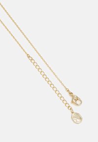 Gold chain necklace featuring round links and a lobster clasp, accented with an octagonal pendant engraved with a design.