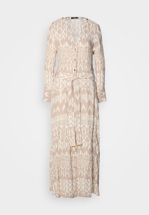 Long beige dress featuring a geometric white pattern, button-down front, long sleeves, and a matching tie belt at the waist.