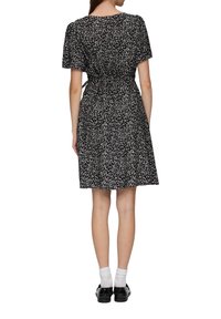 Schwarzes Kleid mit floralem Muster, kurzen Ärmeln und tailliertem Schnitt. Es hat einen knielangen Rock und Bindebänder im Rücken.