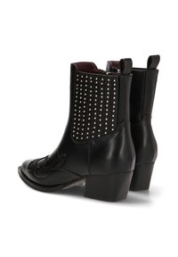 Botines de cuero negro con tacón bloque, punta afilada, costuras decorativas y adornos de tachuelas en la parte posterior.