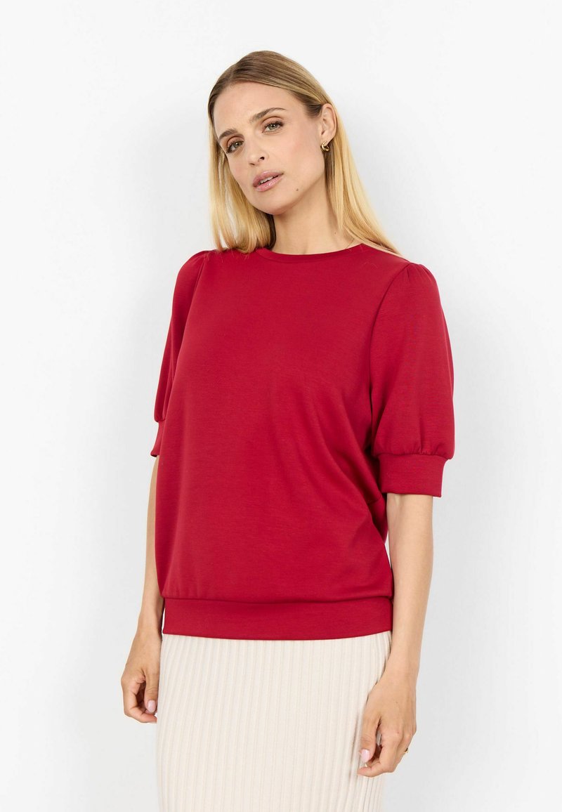 Top corto rosso con maniche a sbuffo arricciate, girocollo e vestibilità rilassata. Tessuto morbido e design a tinta unita.