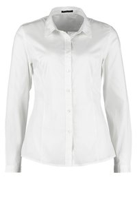 Camicia bianca a maniche lunghe aderente con colletto e bottoni visibili sulla parte anteriore, esposta su uno sfondo semplice.