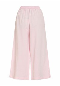 Pantalon large rose clair avec taille élastique et tissu fluide et ample.