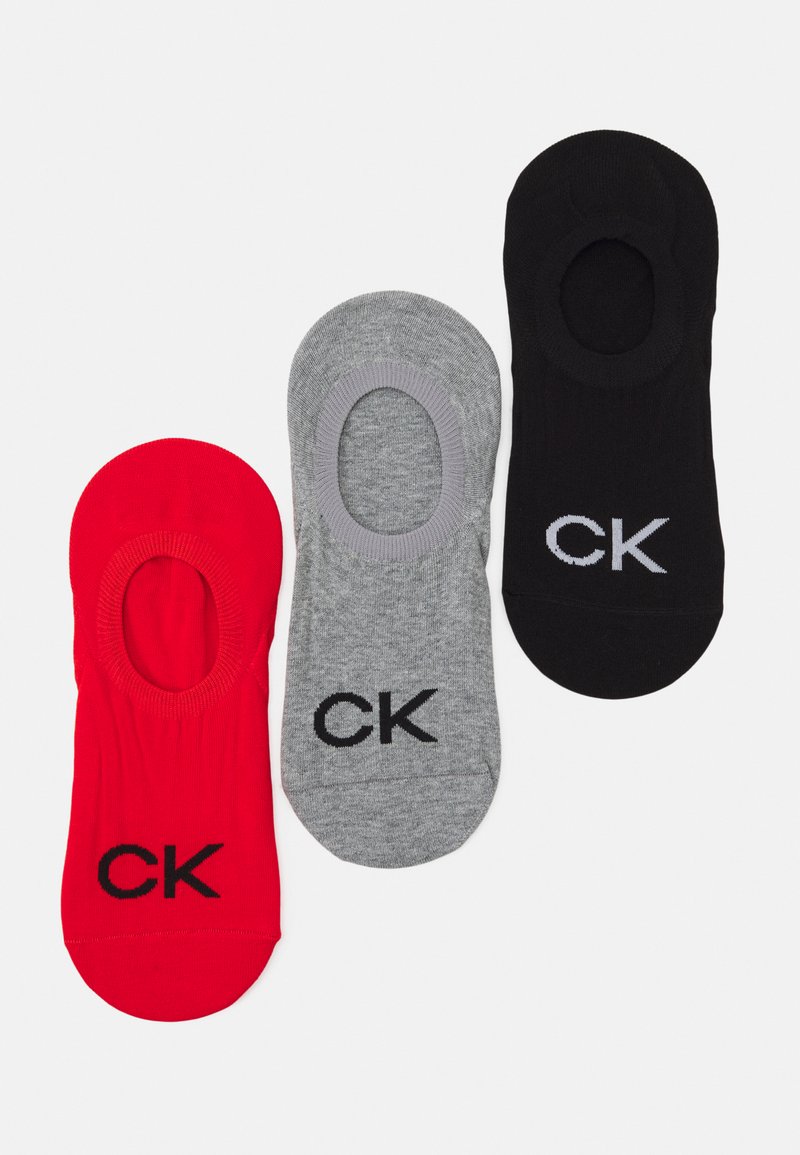 Tre paia di calzini corti in rosso, grigio e nero, caratterizzati da una texture liscia e un logo CK ricamato sul lato.