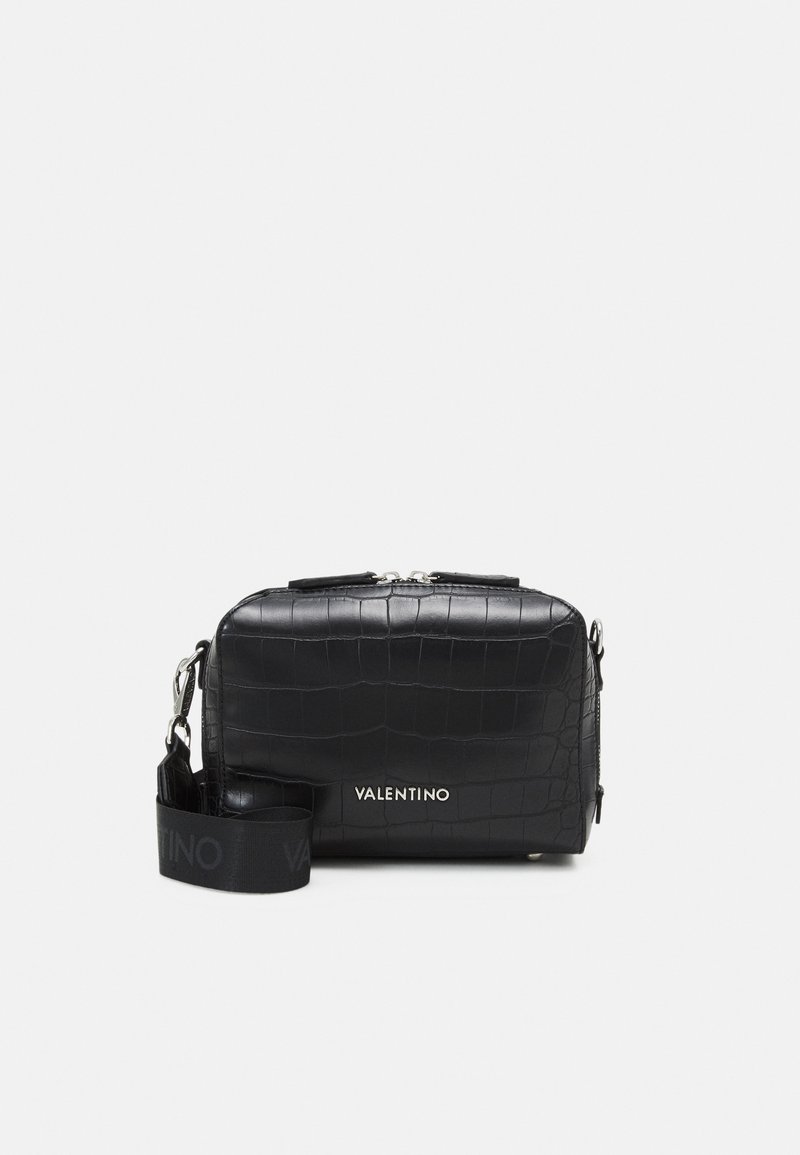 Black textured leather crossbody bag with a crocodile pattern, silver hardware, top zip closure, and a logo-embossed adjustable strap.
