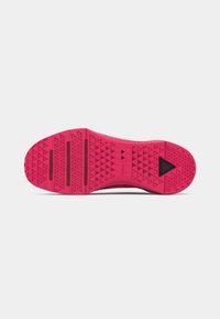 Bright pink shoe sole with textured triangular patterns, three horizontal grooves near the toe, and a black triangular detail near the heel.