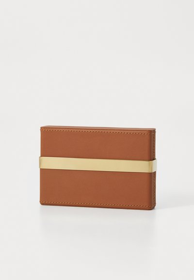 Brown leather wallet with a smooth texture, featuring a gold metal band across the center. Rectangular shape with stitched edges.