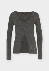 Camicia a maniche lunghe di colore grigio scuro con una texture leggermente consumata, presenta un collo a barchetta e un dettaglio centrale con taglio.